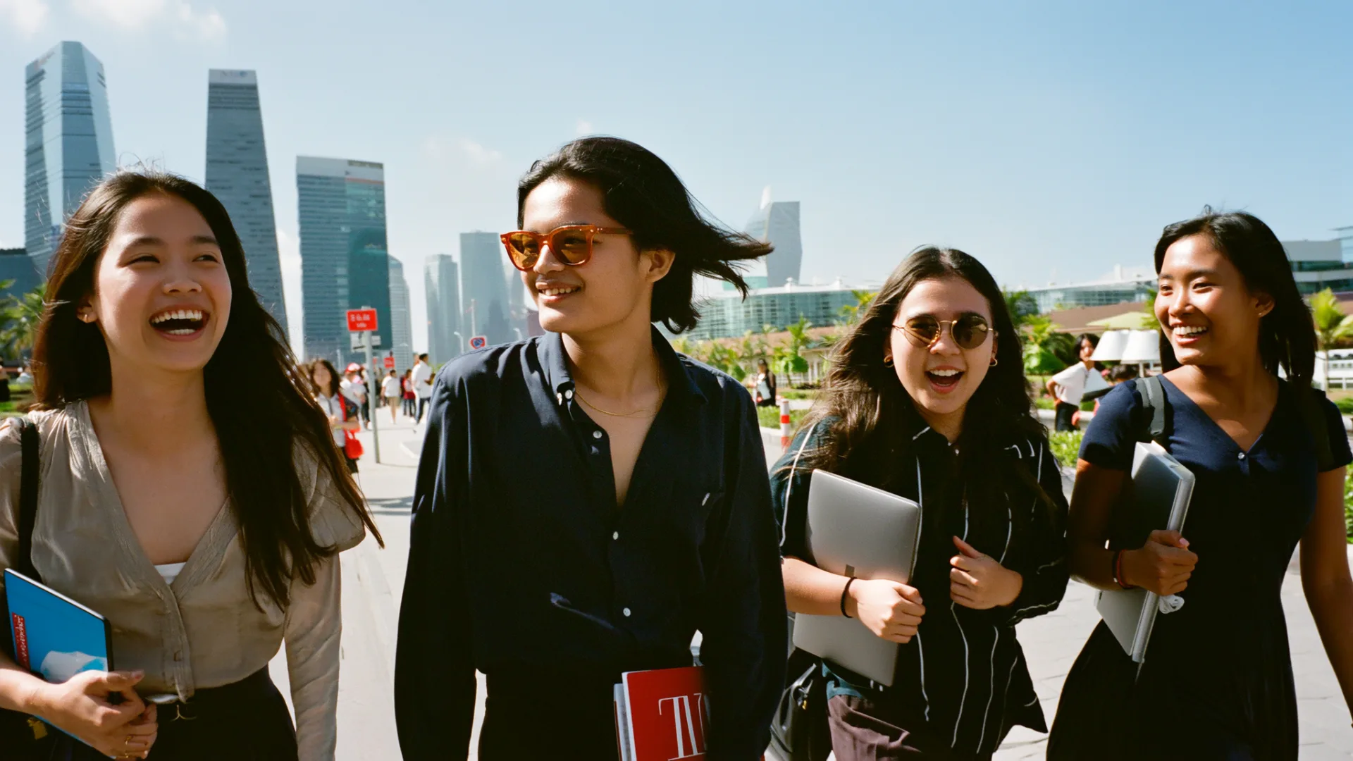 A cohort of young Singaporean students walking through the CBD together
